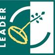 Ein grün-weißes Quadrat mit der Aufschrift "Leader". In der Mitte ist ein Kreis mit einem gelben Symbol.
